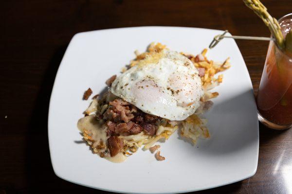 The Mountain Man - Hash browns topped with chucked honey ham, bacon, southern gravy, and two eggs cooked to order - $12