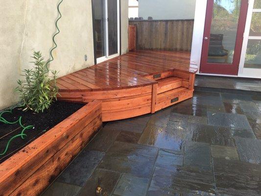 Small deck with steps and planter boxes.