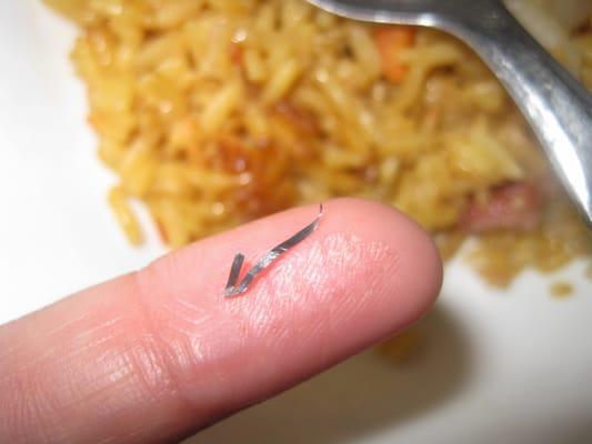 Pointy sharp metal found in pork fried rice.