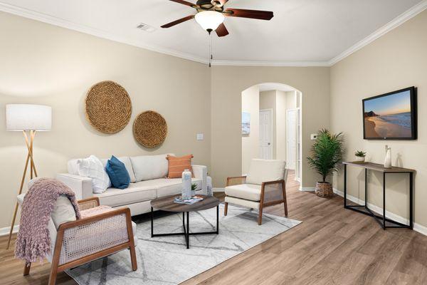 Living room with ceiling fan at the Villas at Medical Center