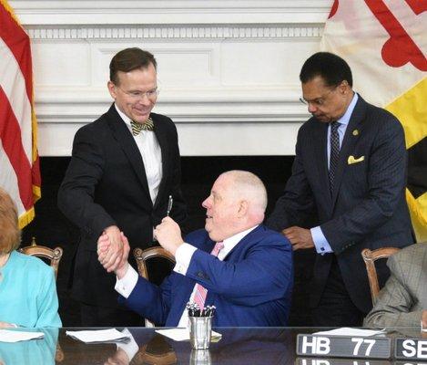 Nicholas Cowie,attorney and  author of legislation, shaking hands with Maryland's Governor Hogan