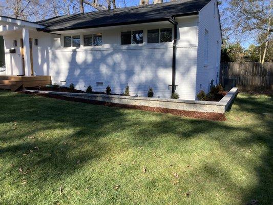 Wall installed, plants/mulch