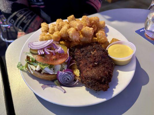 Roasted Chicken Sandwich with tots and a side of honey mustard