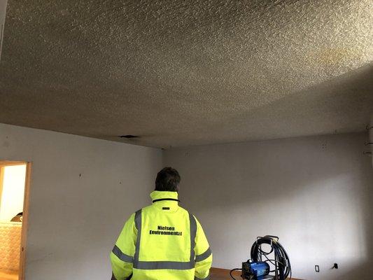 Before - popcorn ceiling in living room.