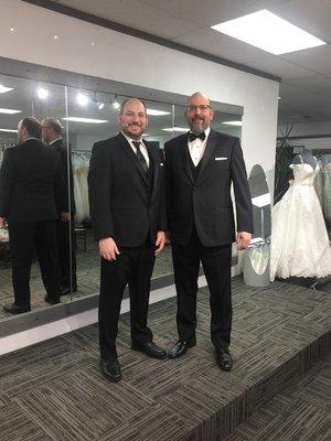 Two tuxedos from Top Tier Tux taken inside Romashka Bridal.