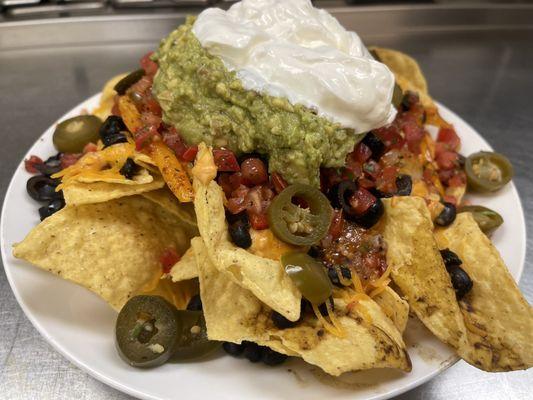 Loaded nachos, with no protein, seasoned black beans, fresh Guacamole, jalapeños, fresh made pico, black olives, shredded cheese, quaso