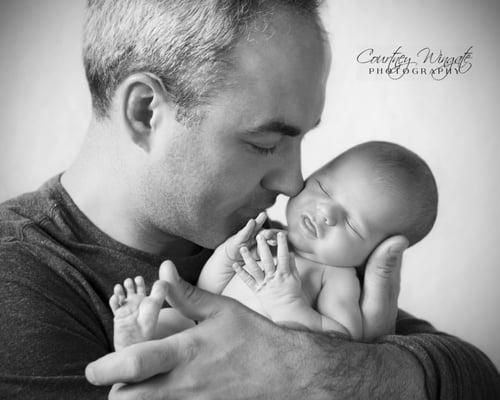 Dad and baby, in home newborn photo shoot.