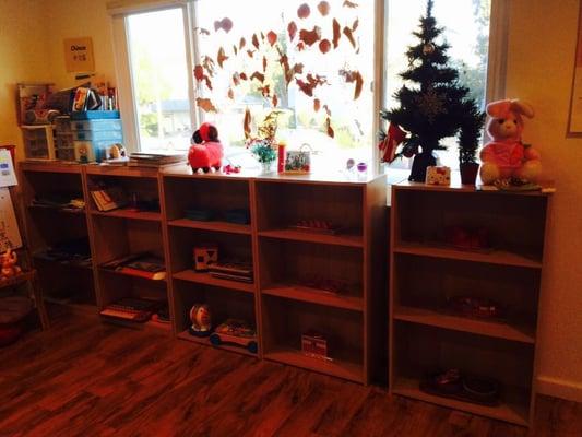 Main room activity center with another row of bookcases of materials.