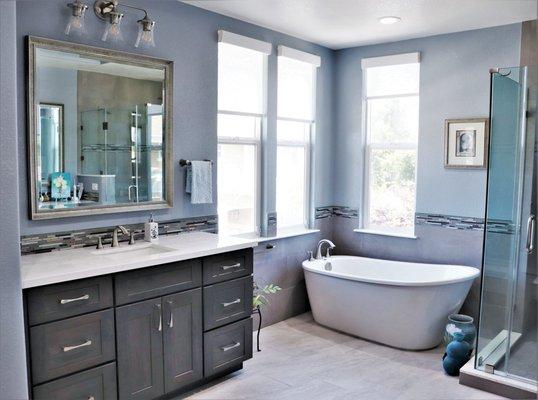 Glorious freestanding tub in a remodeled master with his and her vanities and a walk in shower.