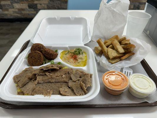 This is picture of the gyro plate with falafel and hummus sides and puts chips from a previous visit.