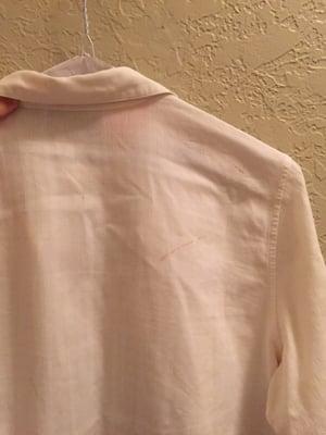 Stain marks on the back of one of my white shirts. The press job is lacking too..... Not crisp at all.