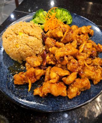 Orange chicken with fried rice and vegetables.