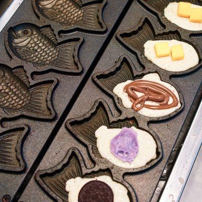 Taiyaki flavors include: Nutella, Oreo, Ube, Red Bean and Cheddar!