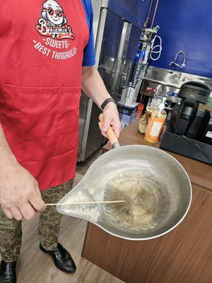 This is the pan they use to dip the fruit skewers into the melted sugar...