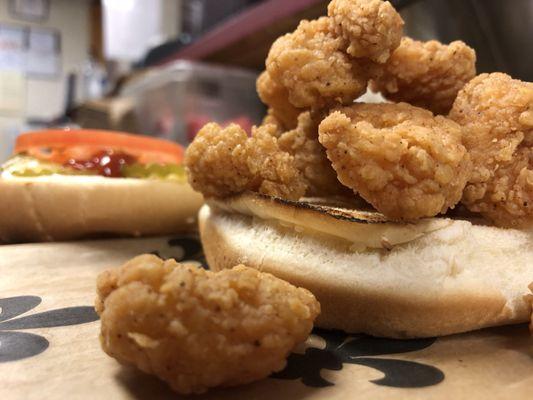 Spicy fried shrimp on a toasted sesame seed bun. Try mayo, mustard, onions, pickle, lettuce & tomato.