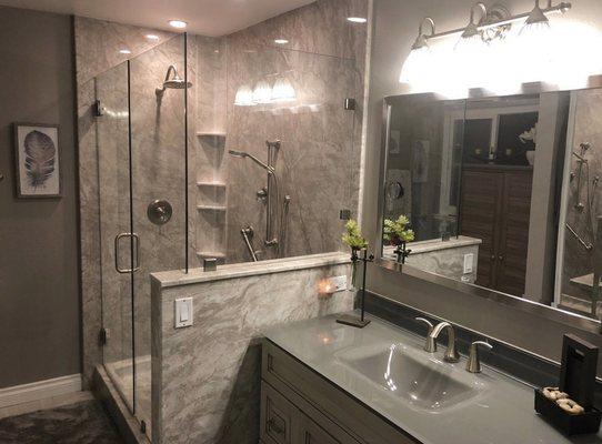 Stunning Pompeii Marble expanded shower, custom frameless glass and vanity.