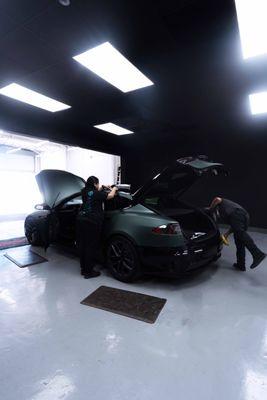 Tesla Model S Being Wrapped in a Matte Pine Green Metallic