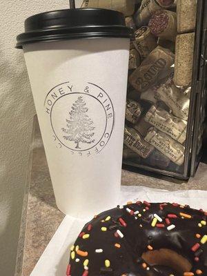 Caramel latte, chocolate donut with sprinkles.