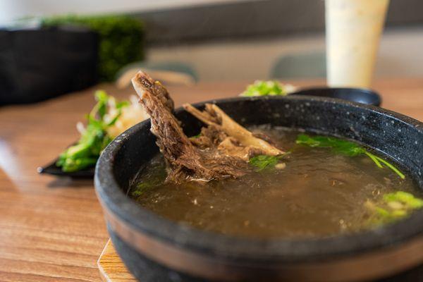 A hearty bowl of pho with tender beef ribs in rich broth--comfort food at its finest.