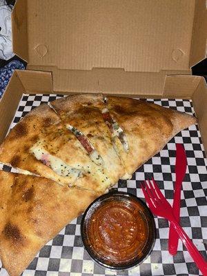 Calzone with pepperoni sausage canadian bacon and basil