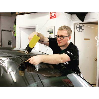 Tyler shrinking a front windshield...yes we tint those too!