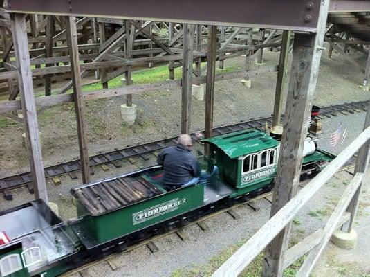 Train running underneath waiting in the queue line.