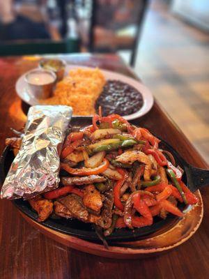 Steak Asada with rice and re-fried beans.