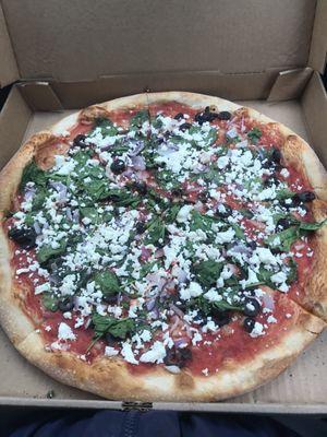 This is the La Greca. Thin crust with black olives, onions, spinach, sauce, and olive oil.