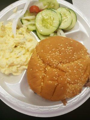 Pork sandwich Potatoe salad and some salad thing