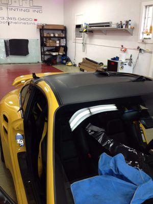 3M 1080 Matte Black film being applied on roof top for a custom look.