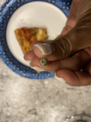 Metal rivet in pizza