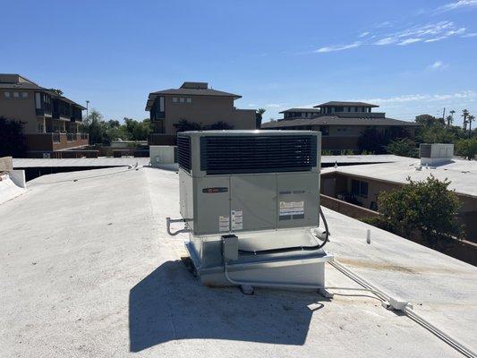 15 SEER Trane package heat pump with custom fabricated curb adapter.