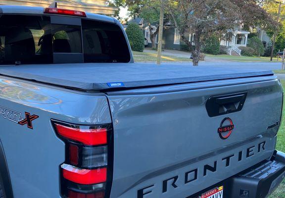 TonnoPro Tri-Fold Tonneau Cover installed on 2024 Nissan Frontier Pro X