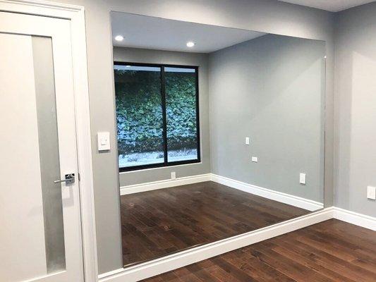 Newly installed wall-sized mirror (100 x 78) in our newly renovated room.