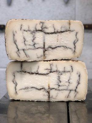 Moliterno with Truffles, a luxurious cheese made with fresh sheep's milk and earthy truffles.