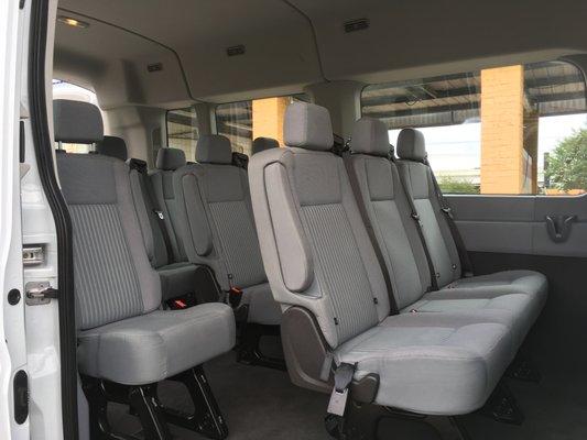 Ford Transit Van. Enough headroom to stand and split row seating allowing easy access.