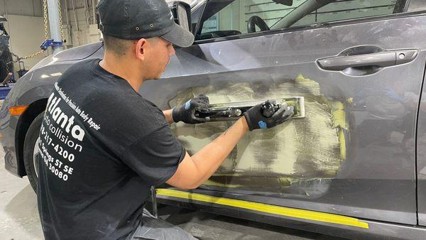 sanding the door after applying the bondo auto body filler