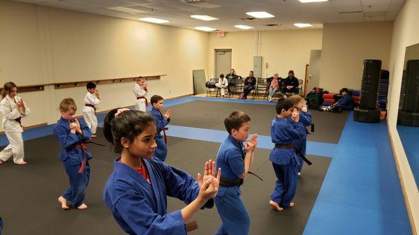 Practicing form to develop focus, self-control, and coordination in our advance martial arts class for 6 to 12 year olds