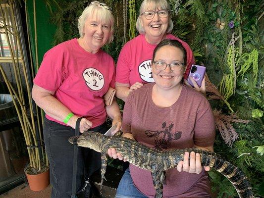 Some family holding an alligator