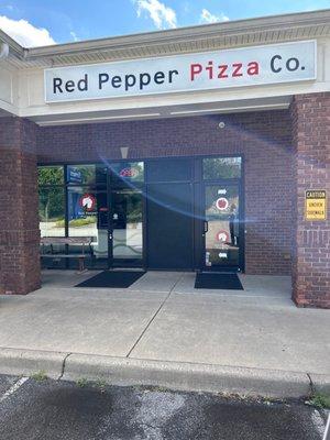 Entrance to the left of Red Pepper Deli