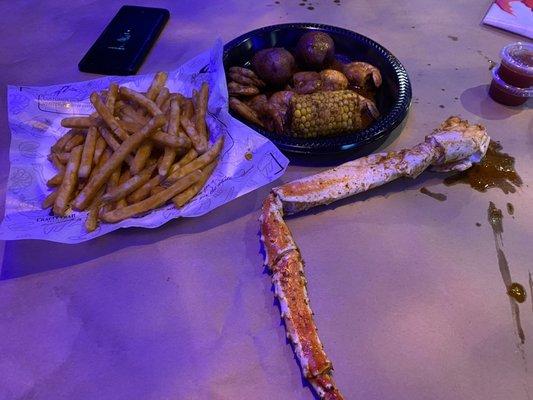 Single crab leg, one piece of corn, 10 shrimp, and $6 worth of fries.