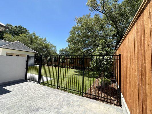 Gorgeous combination fence separating the yard for the dog.