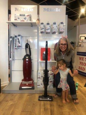 Grandma and grandchild getting a new vacuum cleaner