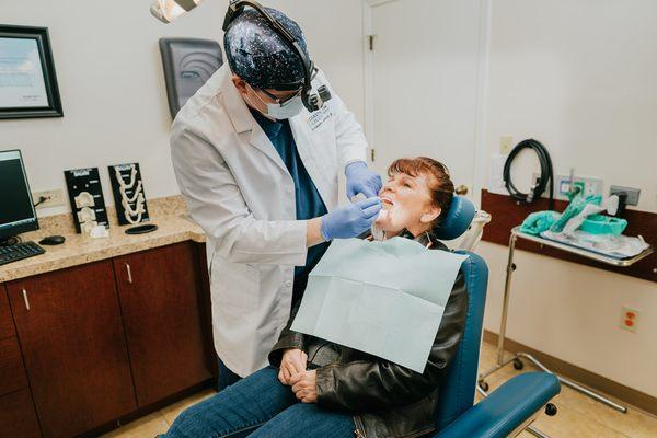 Dr. Kenneth L. Anderson III, oral surgeon at Coastal Jaw Surgery, exams a patient in Spring Hill Florida.