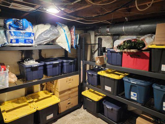 AFTER: Basement corner- Client bought and we assembled shelving unit. Filled and labeled bins.