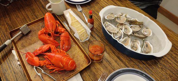 Lobster, oysters, cocktail sauce, and crackers. Ready to eat.