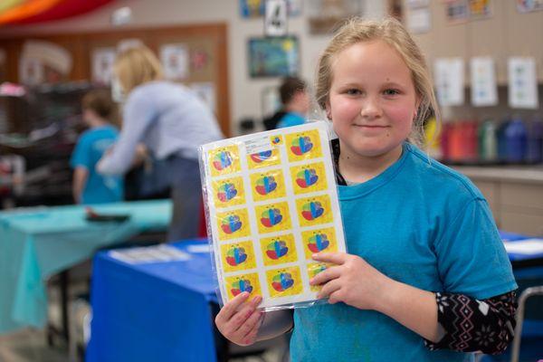 A student shares her artwork and the stickers we created with it.