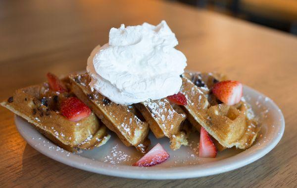 Sweet Grace: Chocolate chip vanilla waffle, topped with strawberries, powdered sugar, whipped cream, served with Bissell Farms maple syrup.