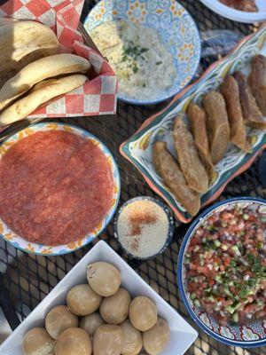 Pita, babaganoush, jachnun, hard boiled eggs and Israeli salad