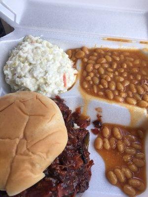 Pulled pork sandwich with baked beans and coleslaw combo